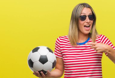 Futbol futbol topu izole arka plan üzerinde çok mutlu el ve parmak ile işaret tutan genç güzel kadın