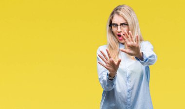Üzerinde gözlük takan genç güzel sarışın iş kadını şokta bağırarak arka plan korkuyor ve dehşet korku ifade dur hareketi el ile ile izole. Panik kavramı.