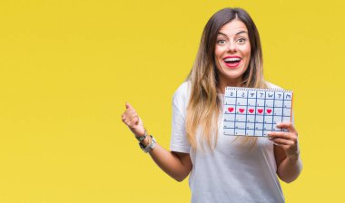 Duygu tezahürat adet takvim gurur çığlık ve zafer ve başarı çok heyecanlı, kutluyor izole arka plan üzerinde tutan genç güzel kadın