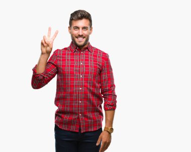 Yakışıklı delikanlı gösterilen ve parmakları ile işaret izole arka plan üzerinde ikincisi ise kendinden emin ve mutlu gülümseyerek.