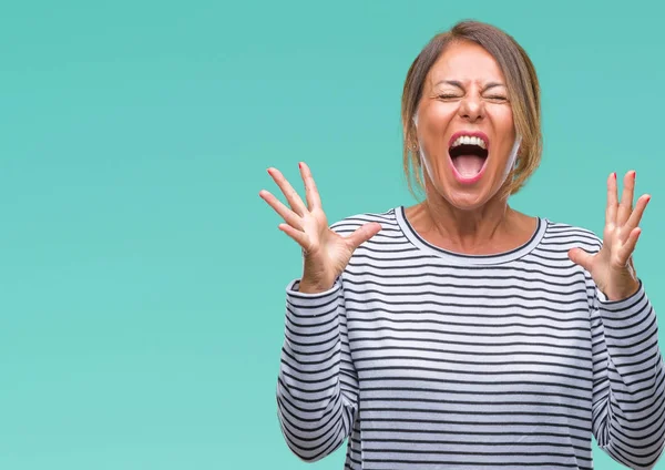 Orta yaş üst düzey İspanyol kadın yüzünden kızgın ve silah ile başarı için deli kutluyor izole arka plan ortaya çıkar ve heyecanlı çığlık gözler kapalı. Kazanan kavramı