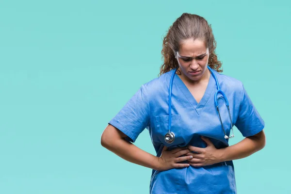 Young brunette doctor girl wearing nurse or surgeon uniform over isolated background with hand on stomach because nausea, painful disease feeling unwell. Ache concept.