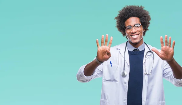非裔美国医生的人在孤立的背景显示和指向与手指数字九同时微笑自信和快乐 — 图库照片