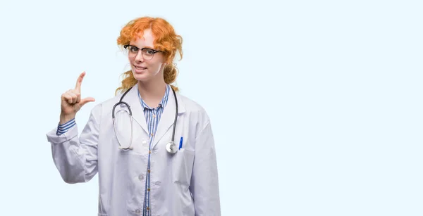 Young Redhead Woman Wearing Doctor Uniform Smiling Confident Gesturing Hand — Stock Photo, Image