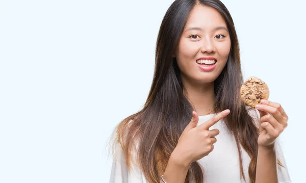 Young Asian Woman Eating Chocolate Chip Cookie Isolated Background — Stock Photo, Image