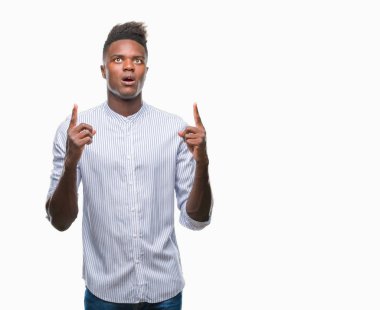 Genç Afro-Amerikan adam izole arka plan üzerinden hayran ve yukarıya bakıp parmakları ile işaret şaşırttı ve silah kaldırdı.