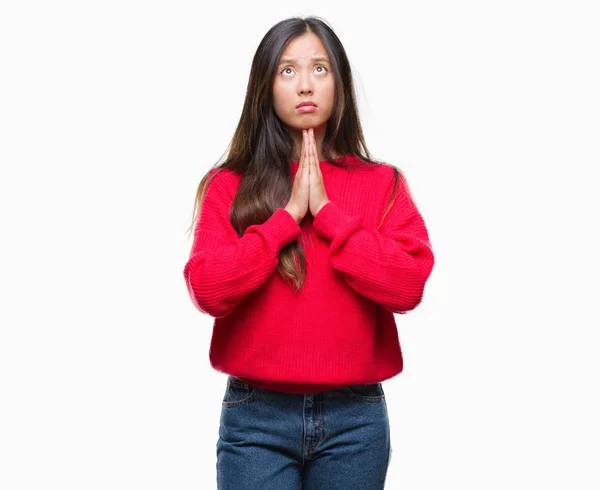 懇願するような手で一緒に祈って分離の背景に冬のセーターを着ている若いアジア女性 — ストック写真