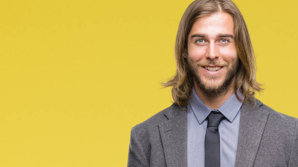 Young handsome business man with long hair over isolated background with a happy and cool smile on face. Lucky person.