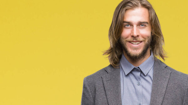 Young handsome business man with long hair over isolated background with a happy and cool smile on face. Lucky person.