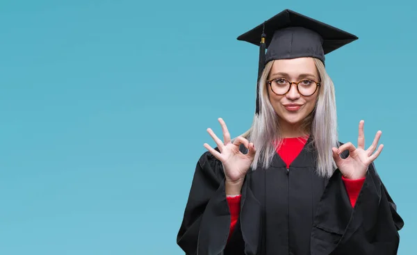 分離の背景の上の大学院の制服を着て若いブロンドの女性リラックスして瞑想の指ジェスチャーをやって閉じた目と笑顔します ヨガの概念 — ストック写真