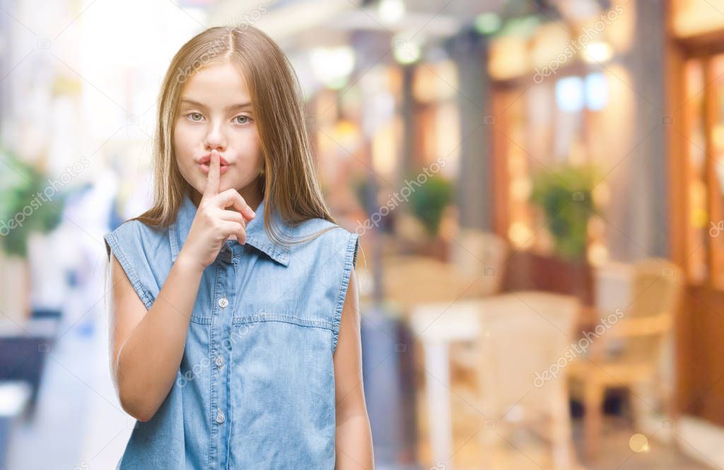 Young beautiful girl over isolated background asking to be quiet with finger on lips. Silence and secret concept.