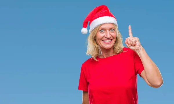 Medelålders Blond Kvinna Bär Jul Hatt Över Isolerade Bakgrund Pekande — Stockfoto