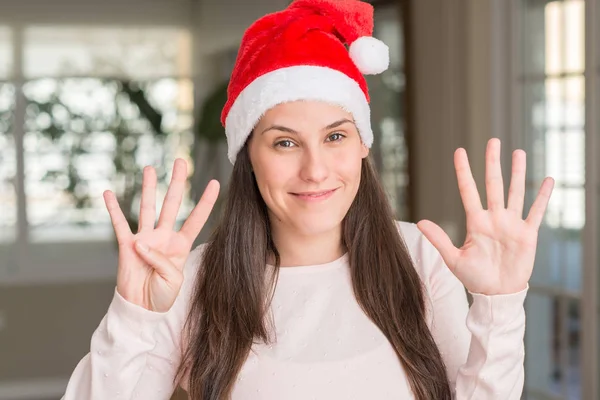 Krásná Mladá Žena Nosí Santa Claus Klobouk Doma Ukazující Směřující — Stock fotografie