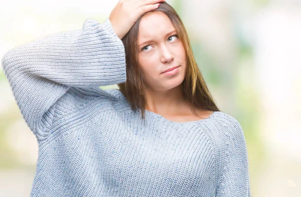 Young beautiful caucasian woman wearing winter sweater over isolated background confuse and wonder about question. Uncertain with doubt, thinking with hand on head. Pensive concept.
