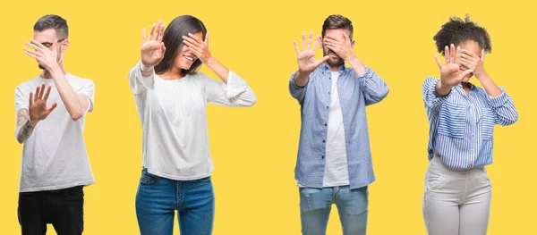集体的人 妇女和男子在五颜六色的黄色孤立的背景覆盖眼睛用手和做停止手势与悲伤和恐惧的表情 尴尬和消极的概念 — 图库照片