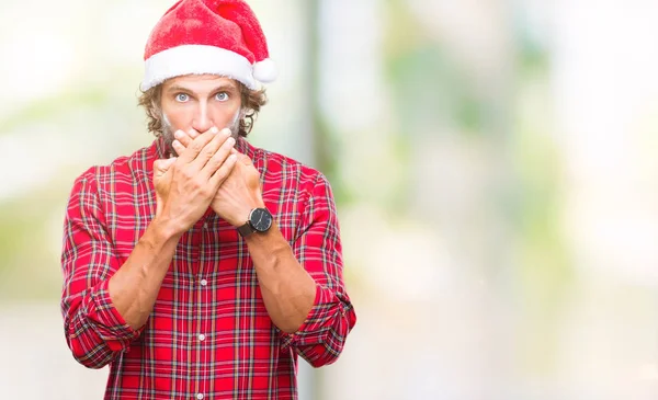 サンタ クロースを着てハンサムなヒスパニック系男性モデルのミスのための手で口を覆っているショックを受けた分離の背景の上のクリスマス 秘密の概念 — ストック写真