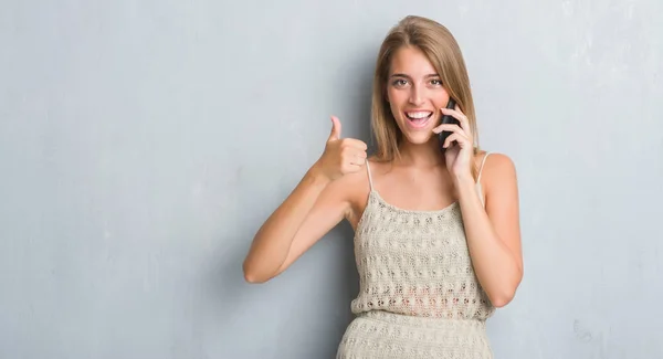 Beautiful Young Woman Grunge Grey Wall Speaking Phone Happy Big — Stock Photo, Image