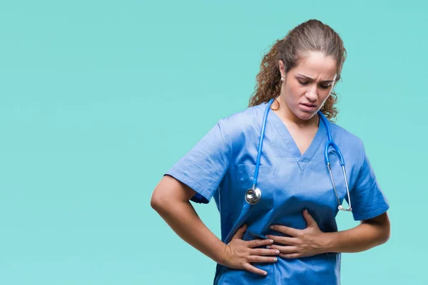Young brunette doctor girl wearing nurse or surgeon uniform over isolated background with hand on stomach because indigestion, painful illness feeling unwell. Ache concept.