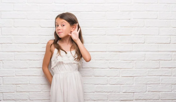 Young Hispanic Kid White Brick Wall Smiling Hand Ear Listening — Stock Photo, Image