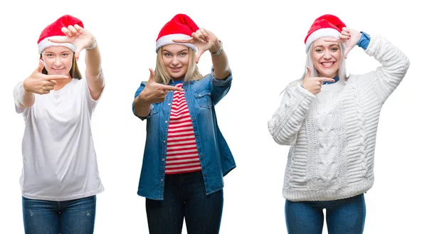 一群年轻女性在孤立的背景微笑的背景上戴着圣诞帽 用双手和手指用快乐的脸制作框架 创意和摄影理念 — 图库照片