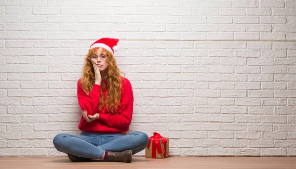 Young Redhead Woman Sitting Brick Wall Wearing Christmas Hat Thinking — Stock Photo, Image