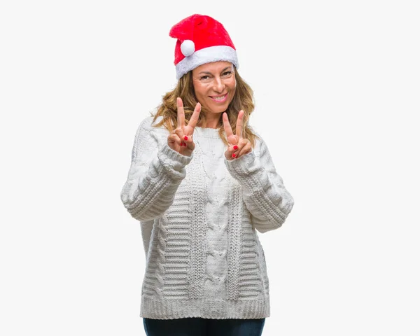 히스패닉 표시를 손가락을 보여주는 카메라를 크리스마스 모자를 — 스톡 사진