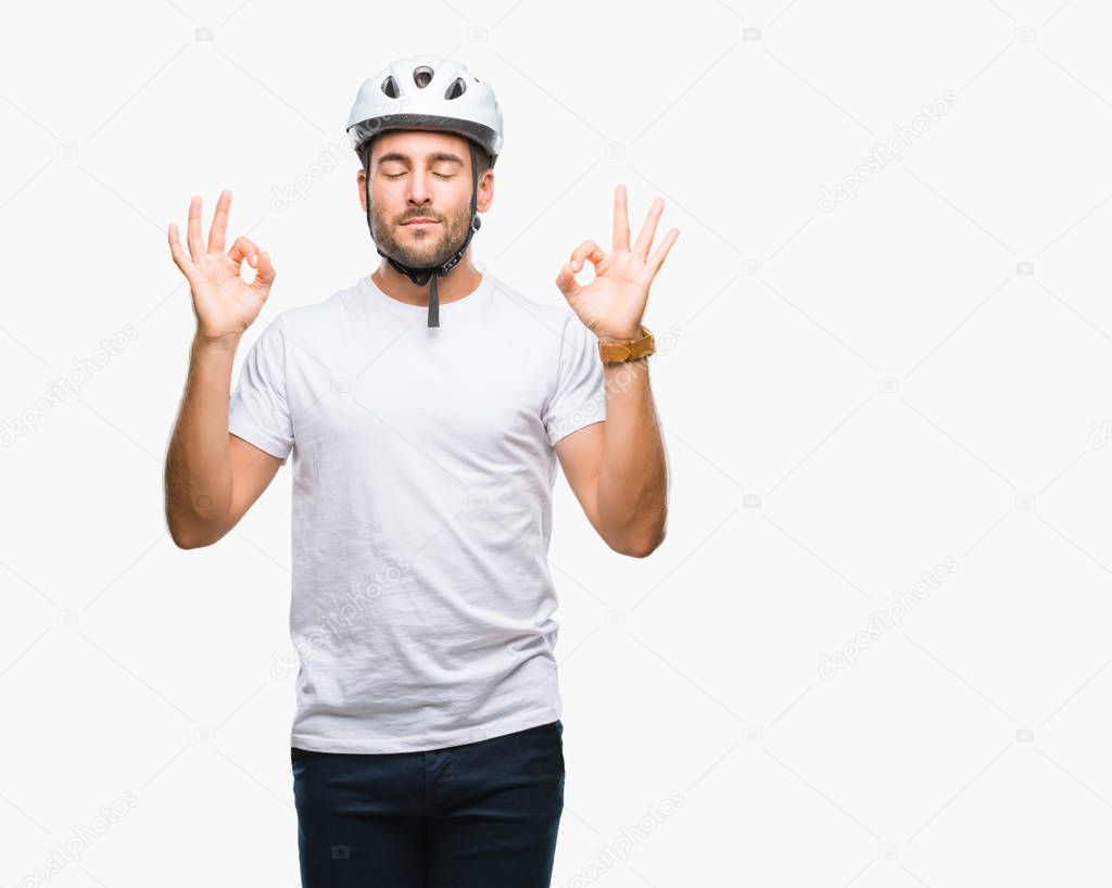 Young handsome man wearing cyclist safety helmet over isolated background relax and smiling with eyes closed doing meditation gesture with fingers. Yoga concept.