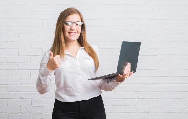 Joven Mujer Negocios Adulta Sobre Pared Ladrillo Blanco Sosteniendo Computadora —  Fotos de Stock