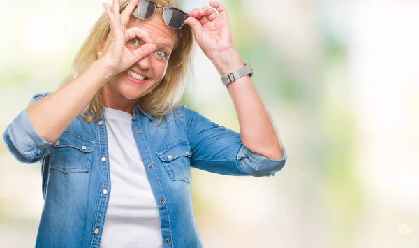 Blonde Frau Mittleren Alters Trägt Sonnenbrille Über Isoliertem Hintergrund Und — Stockfoto