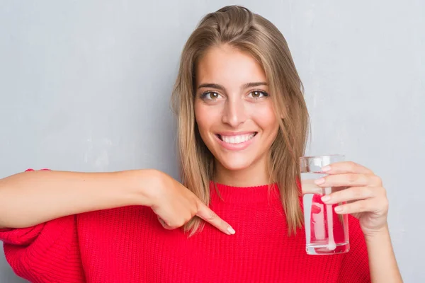 Vacker Ung Kvinna Över Grunge Grå Vägg Dricka Ett Glas — Stockfoto