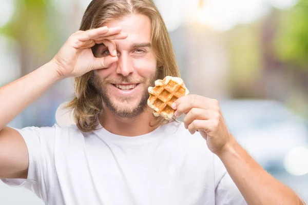 Young Handsome Man Long Hair Isolated Background Eating Waffle Happy — Stock Photo, Image