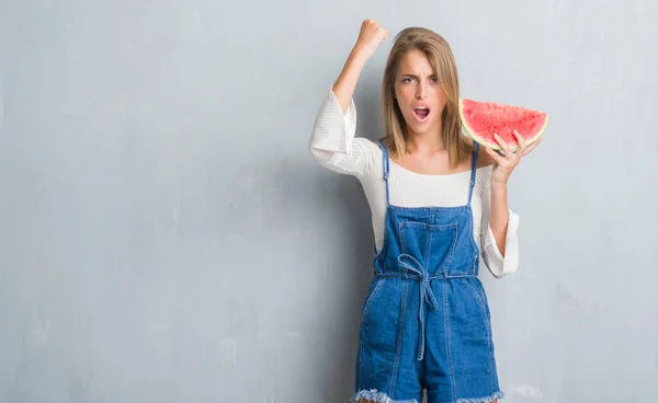 Beautiful Young Woman Grunge Grey Wall Eating Water Melon Annoyed — Stock Photo, Image