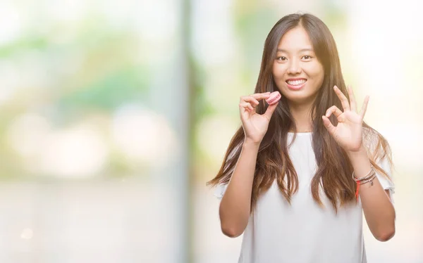 Young Asian Woman Eating Pink Macaron Sweet Isolated Background Doing — Stock Photo, Image