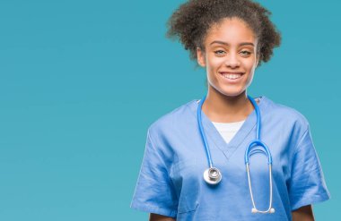 Genç afro Amerikalı doktor kadın yüzünde mutlu ve güzel bir gülümseme ile izole arka plan yüzünden. Şanslı kişi.
