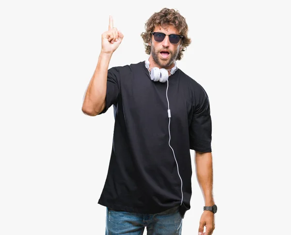 Handsome Hispanic Man Listening Music Wearing Headphones Isolated Background Pointing — Stock Photo, Image