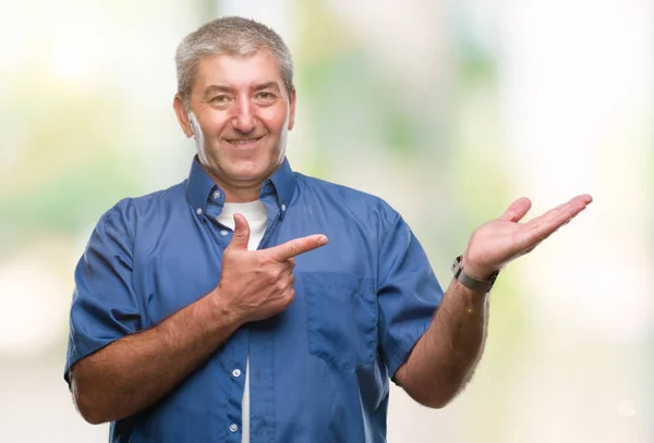 Handsome Senior Man Isolated Background Amazed Smiling Camera While Presenting — Stock Photo, Image