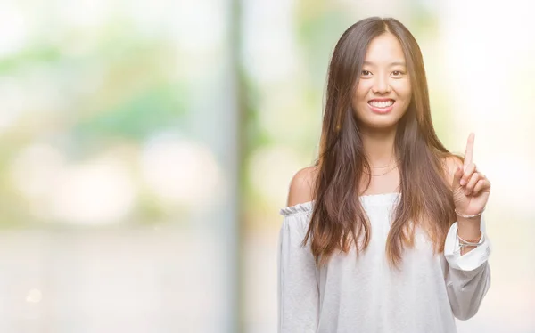 Young Asian Woman Isolated Background Showing Pointing Finger Number One — Stock Photo, Image