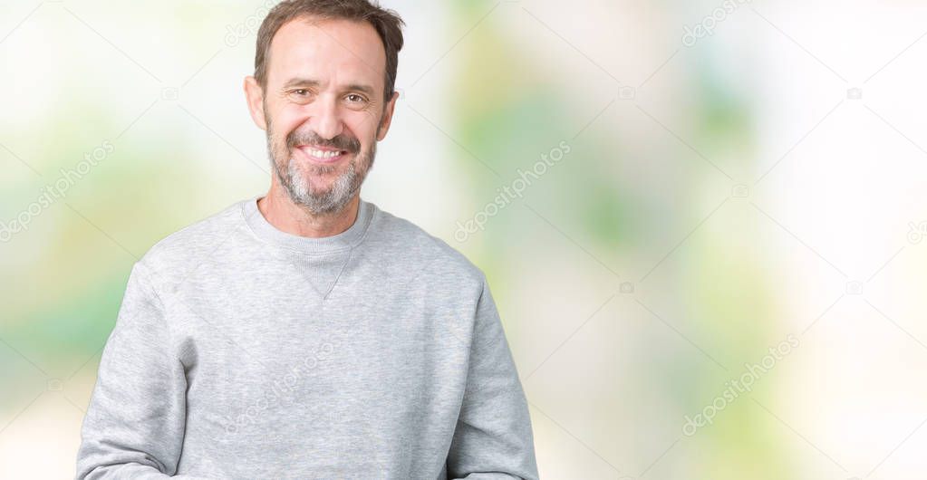 Handsome middle age senior man wearing a sweatshirt over isolated background Hands together and fingers crossed smiling relaxed and cheerful. Success and optimistic