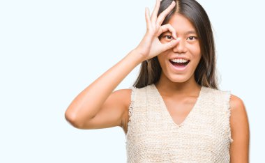 Genç Asyalı kadın gülümsüyor, parmakları ile mutlu yüz üzerinden seyir göz el ile ok jest yapıyor izole arka plan üzerinde.