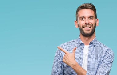 İzole arka neşeli bir gülümseme ile el ve parmak kadar kameraya bakarak yüzündeki mutlu ve doğal ifade ile yan ile işaret yüz üzerinden beyaz t-shirt giyen genç yakışıklı adam.