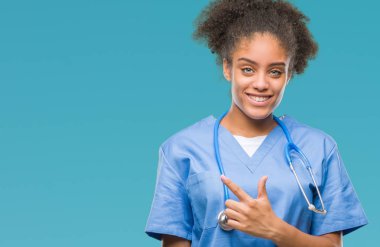 İzole arka neşeli bir gülümseme ile el ve parmak kadar kameraya bakarak yüzündeki mutlu ve doğal ifade ile yan ile işaret yüz genç afro Amerikalı doktor kadın.