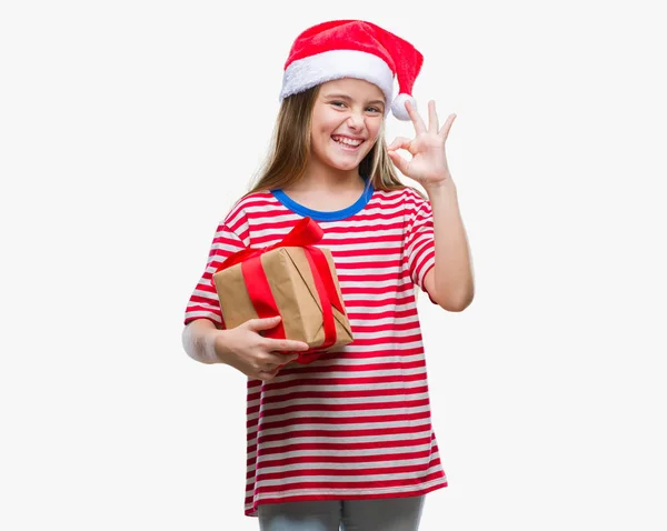 Young Beautiful Girl Wearing Christmas Hat Holding Gift Isolated Background — Stock Photo, Image