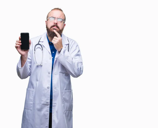 Young Doctor Man Showing Smartphone Screen Isolated Background Serious Face — Stock Photo, Image