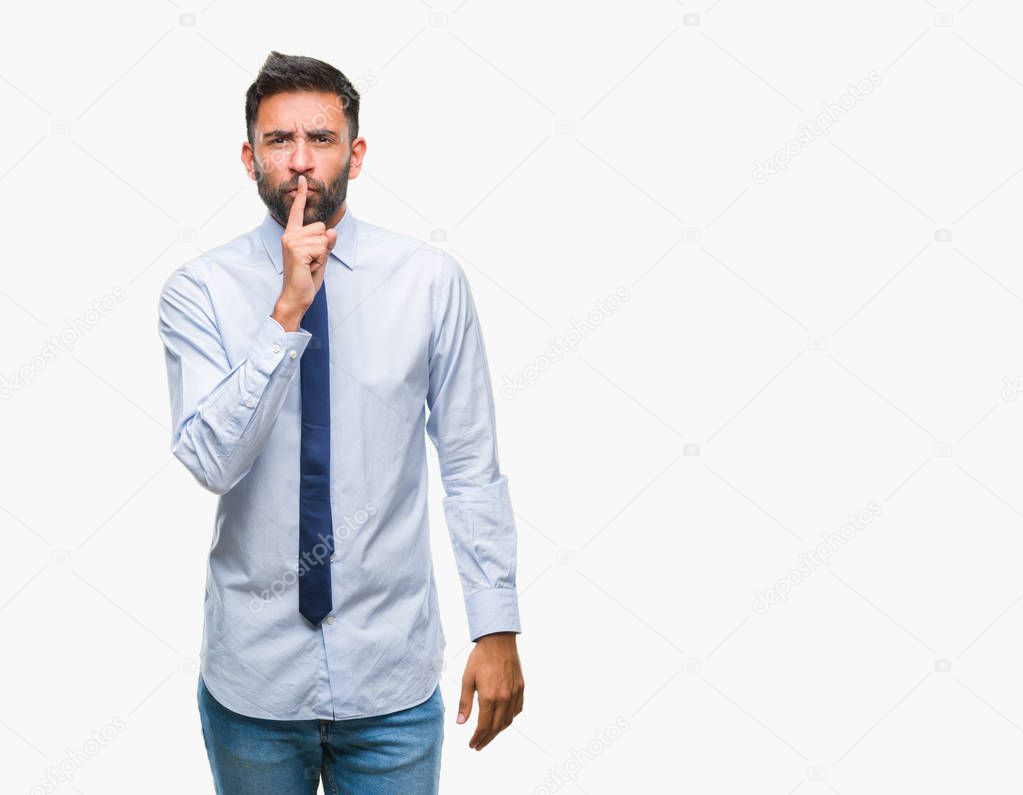 Adult hispanic business man over isolated background asking to be quiet with finger on lips. Silence and secret concept.