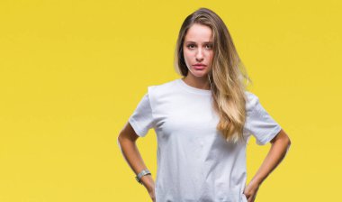 İzole arka plan üzerinde rahat beyaz t-shirt giyen genç güzel sarışın kadın depresif ve kızgın ve korkmuş ağlıyor sıkıntı için endişeleniyorum. Üzgün ifade.