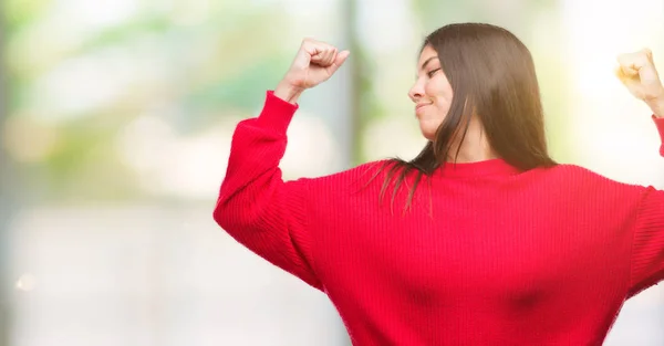 Young Beautiful Hispanic Wearing Red Sweater Showing Arms Muscles Smiling — Stock Photo, Image