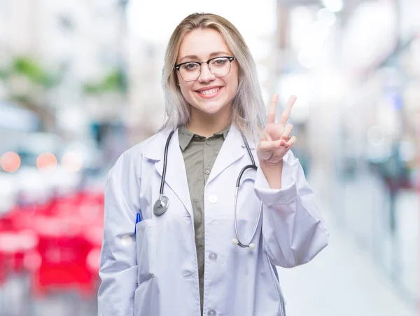 Young blonde doctor woman over isolated background showing and pointing up with fingers number two while smiling confident and happy.