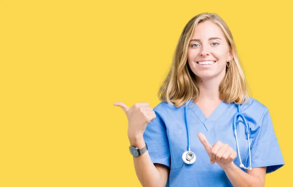 Hermosa Joven Doctora Vistiendo Uniforme Médico Sobre Fondo Aislado Señalando — Foto de Stock