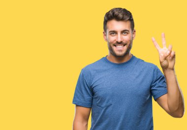 Yakışıklı delikanlı gösterilen ve parmakları ile işaret izole arka plan üzerinde ikincisi ise kendinden emin ve mutlu gülümseyerek.