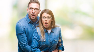 Aşık korkuyor ve şok sürpriz ifade, korku ve heyecan yüz ile izole arka plan üzerinde gözlük takan genç çift.